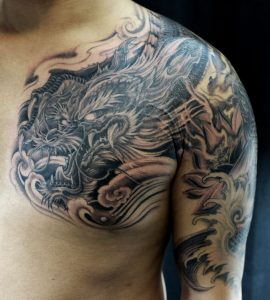 Black Ink Dragon Tattoo On Man Left Half Sleeve And Chest in size 1348 X 1500