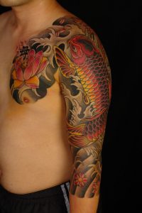 Lotus Flower And Koi Japanese Tattoo On Chest And Sleeve For Men for size 1067 X 1600
