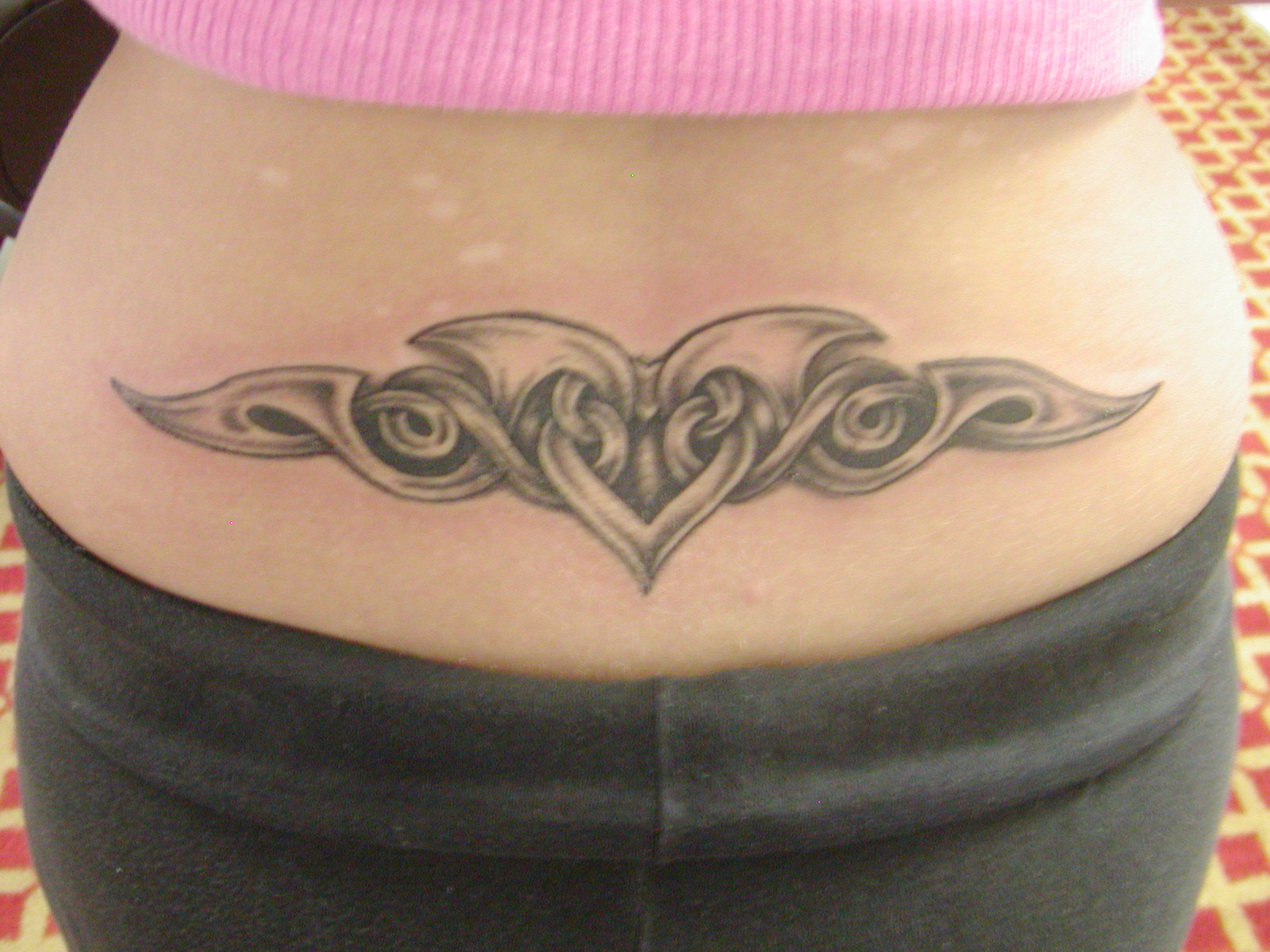 Grey Tribal Heart Lower Back Tattoo For Women for proportions 1600 X 1200