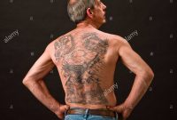 One Caucasian Male Man W Multiple Tattoos On Back Stock Photo within size 1300 X 1065