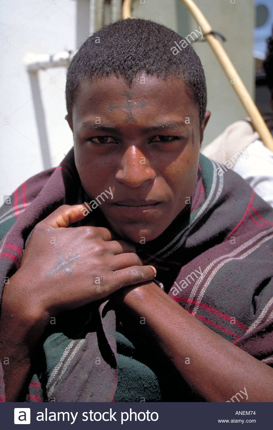 Young Man With Blue Cross Tattoos On Forehead And Hands Indicating pertaining to dimensions 882 X 1390