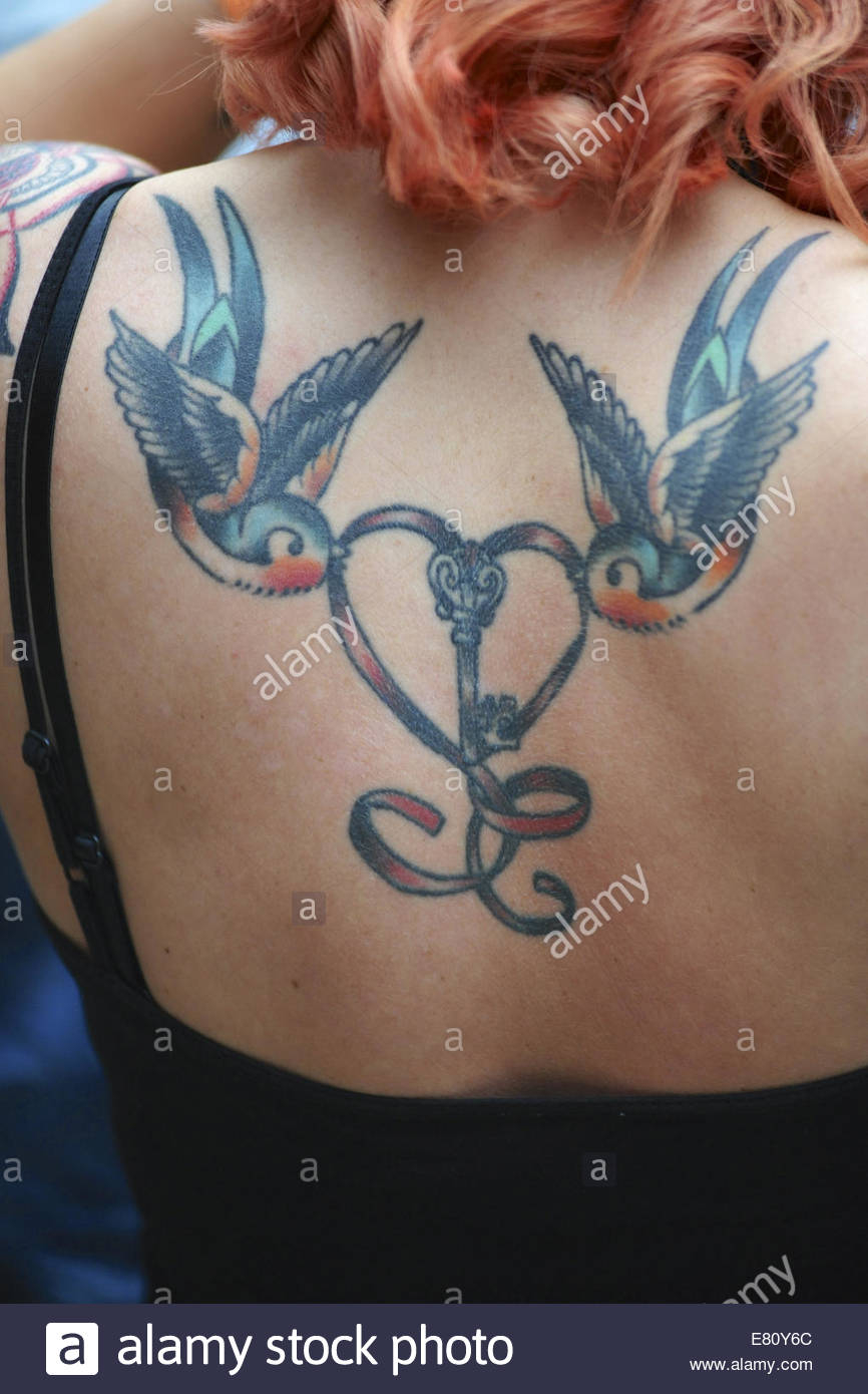 A Woman With A Double Swallow Design On Her Shoulder Blades At The for size 866 X 1390