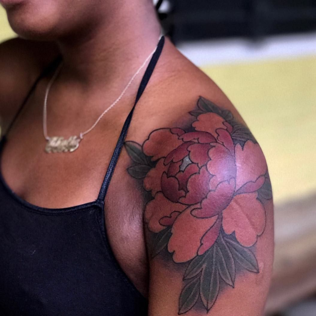 Colored rose tattoos on black skin